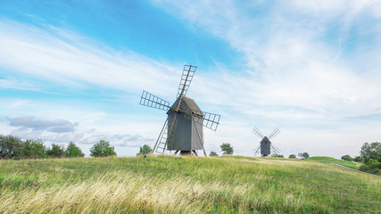Fototapeta na wymiar Old Wooden Windmills on Beautiful Landscape. Oland, Sweden.