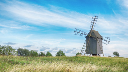 Fototapeta na wymiar Old Wooden Windmills on Beautiful Landscape. Oland, Sweden.