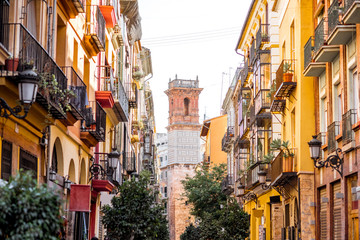 Fototapeta na wymiar Street view with beautiful old buildings and saint Bartolomeu tower in Valencia, Spain