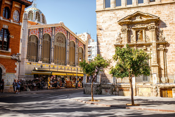 Fototapeta premium Street view with saint Joan church and famous food market Central in Valencia city, Spain