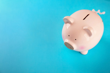 Cute piggy bank on color background
