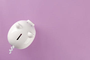 Cute piggy bank on color background