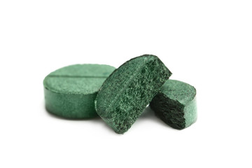 Spirulina tablets on white background