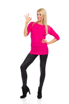 Beautiful Blond Woman Is Standing, Showing Ok Hand Sign And Smiling