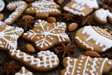 Homemade christmas gingerbread on a wooden background with star anise and almond