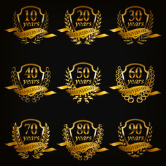 Set of gold anniversary badges with laurel wreaths, numbers. Decorative emblem of jubilee on black background. Filigree element, frame, border, icon, logo for web, page design in vintage style