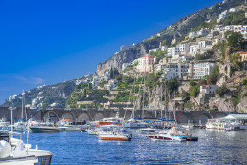 Fototapeta na wymiar Luxury yachts harbor and villas on cliffs, mediterranean coastile, Italy