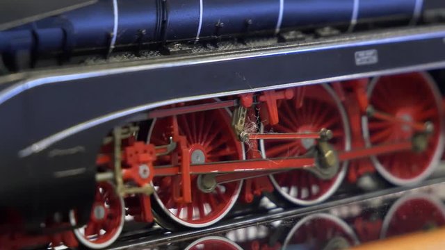Old steam locomotive in motion. Miniature machine model. MODEL HOBBY