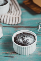 Homemade delicious chocolate muffine on wooden table.