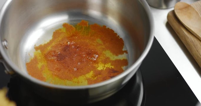 Oil with paprika warmed up in a sauce pan over high heat