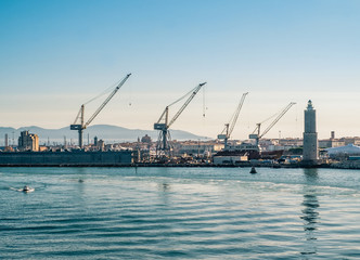 cranes and shipyards in Livorno harbor. Tuscany, Italy.