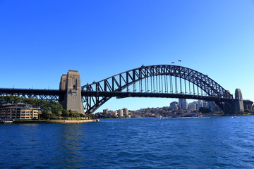 Naklejka premium Sydney Harbour Bridge view from a ferry with stunning blue sky