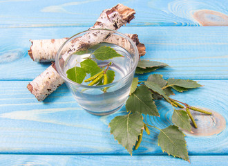 A glass of birch juice on wooden background - 178550751