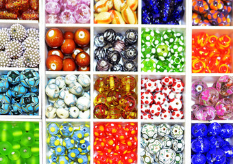 Brightly coloured Lampwork glass beads in a tray