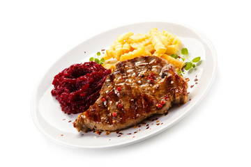 Grilled steak, French fries and vegetables on white background