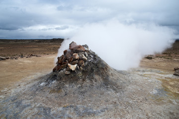 Hverarönd, Iceland. Hot vapors in a typical Icelandic landscape, a wild nature of rocks and shrubs, rivers and lakes.