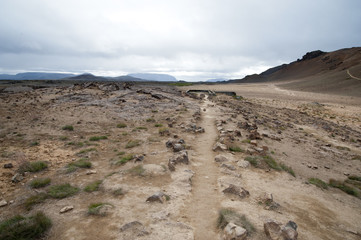 Hverarönd, Iceland. Hot vapors in a typical Icelandic landscape, a wild nature of rocks and shrubs, rivers and lakes.