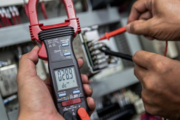 Electrical Engineer is check electrical equipment with a multi-meter