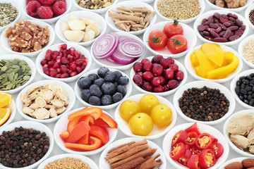Food for a healthy heart with herbal medicine, vegetables, fruit, pulses, seeds and nuts on white...