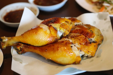 Chicken Grilled and black pepper with spicy sauce. Popular food in Thailand, It is yellowish from grilling or baking.