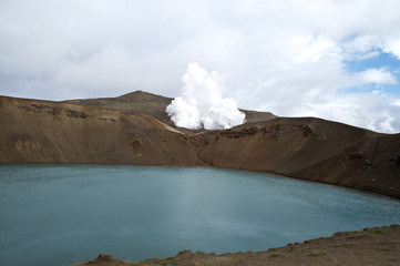Hverarönd, Iceland. Hot vapors in a typical Icelandic landscape, a wild nature of rocks and shrubs, rivers and lakes.