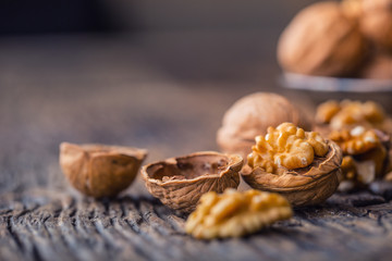 Walnut. Walnut kernels and whole walnuts on rustic old oak table