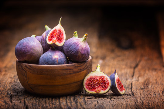 Figs. A few figs in a bowl on an old wooden background