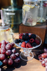 Decorated area with flowers, fruits, raspberry and grapes