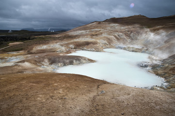 Hverarönd, Iceland. Hot vapors in a typical Icelandic landscape, a wild nature of rocks and shrubs, rivers and lakes.