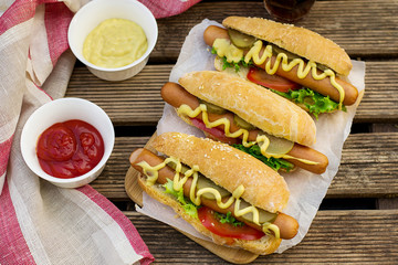 Hot dog in a bun with mustard and vegetables