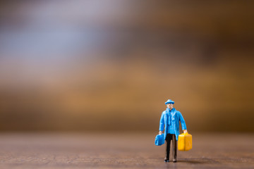 Miniature people travelers standing on wooden background , Travel concept