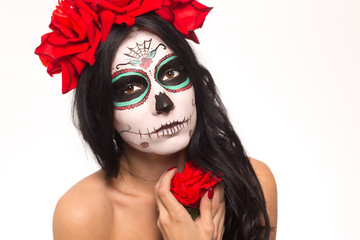 Day of the dead. Halloween. Young woman in day of the dead mask skull face art and rose. Isolated on white. closeup.