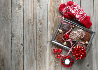 Christmas background with gingerbread and mittens on old wooden desk