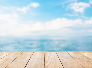 Wooden table top on blue sea and white sand beach