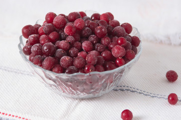 frozen cranberry berries in a plate on a white tablecloth