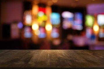 Empty dark wooden table in front of abstract blurred bokeh background of restaurant . can be used for display or montage your products.Mock up for space.