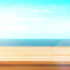 Wood table top on blur sea background. Summer, nature concepts. For montage product display or design key visual layout.
