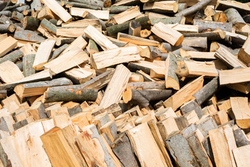 Firewood texture. Stacked firewood heap. Dry chopped firewood logs
