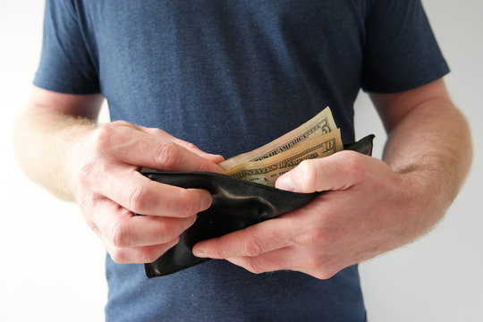 Man pulling out US dollars cash from wallet