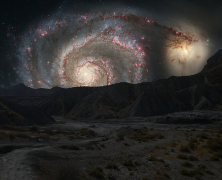 Mountains ridges on the background of outer space galaxy