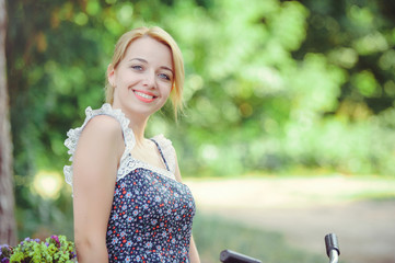 A healthy woman. Beauty Summer model girl with bright flowers happy forest. style leisure. A beautiful white lady. A nice face with a smile and a mystery. place for banner and advertisement