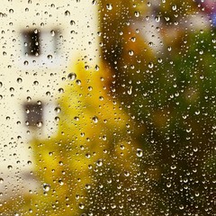 Rain. Autumn seasonal background with rain drops on the window. Autumn cold weather with rain and wind. Abstract colorful background.
