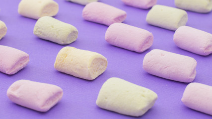 Pattern with marshmallows on violet background