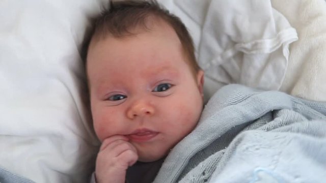 Cute newborn baby in crib, close-up