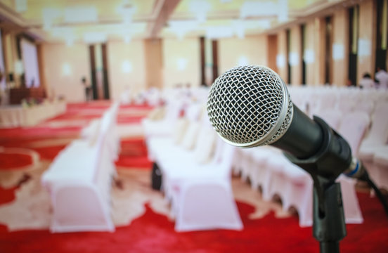 Microphones on abstract blurred of speech in seminar room or front speaking conference hall light, Event Background.