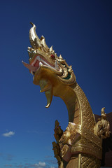 Fototapeta na wymiar Golden Naga Statue, a symbol of mystical, great and wise serpents