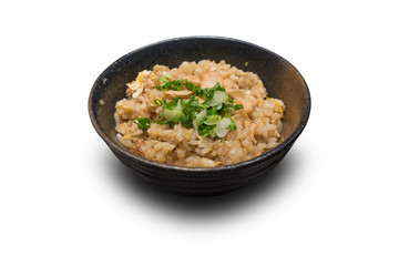 Fried rice with garlic and butter and toping with sliced green onion on traditional cray bowl isolate on white background with clipping path.