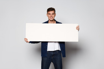 Casual Man holding white papper card on white background at studio