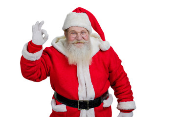Cheerful Santa Claus man showing ok sign. Happy senior Santa Claus with ok sign on white background. Realistic Santa Claus, studio shot.