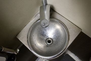 stainless steel sink in the corner of the bathroom on the train. Public toilets on the train.